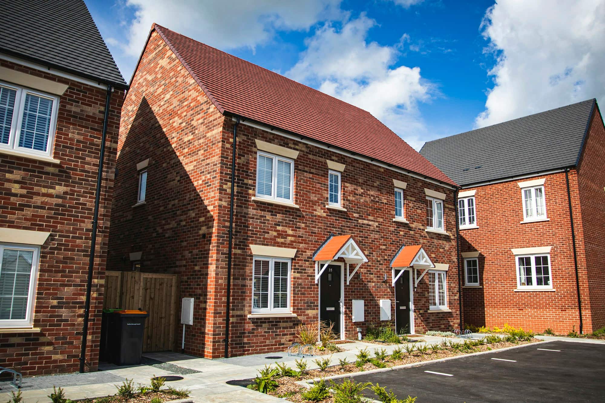 A terrace of contemporary brick family homes on a completed residential development.