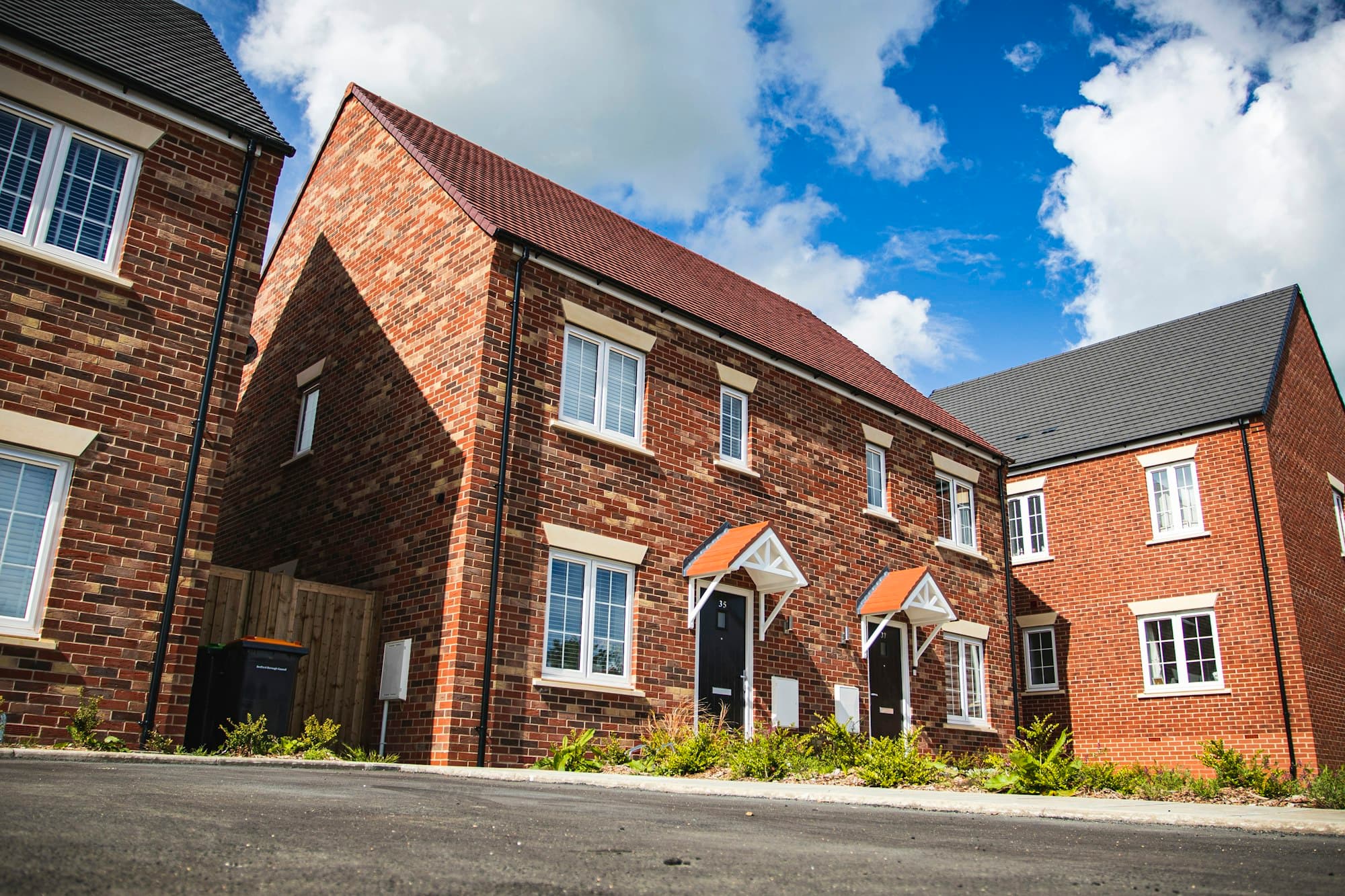 Rows of modern brick family homes on a newly completed residential estate.