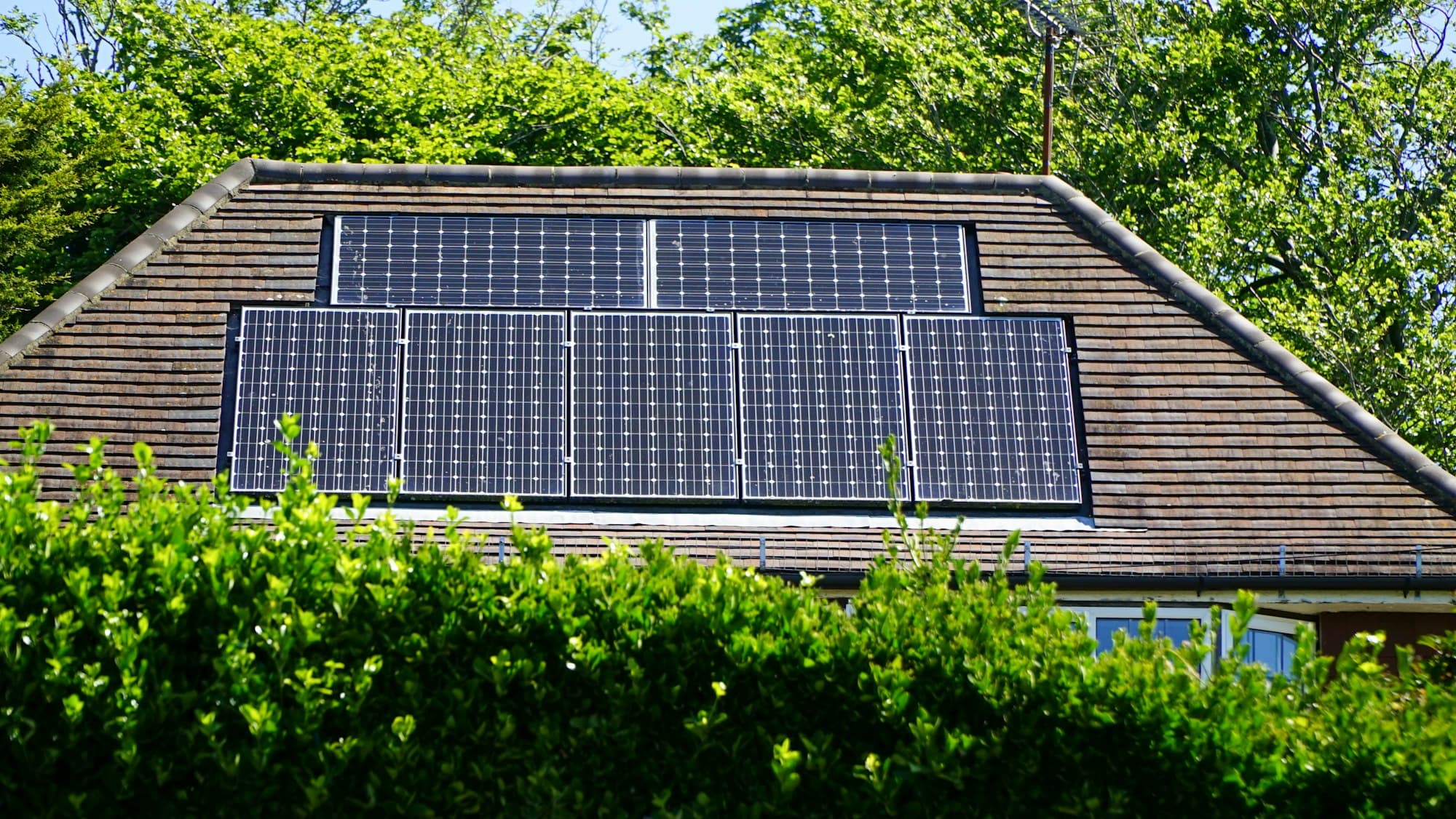 Solar panels integrated into the roof of a modern home.